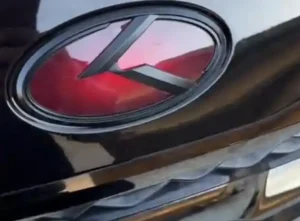 Close-up of Kia Forte's genuine Koup emblem, highlighting the need for replacement