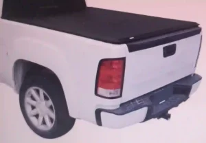 A black RealTruck Gator SFX Tri-Fold Tonneau Cover securely fastened on a pickup truck bed