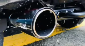 A close-up image of the Ford F150 exhaust system, highlighting its chrome finish and robust build, installed on the rear underside of the truck. 