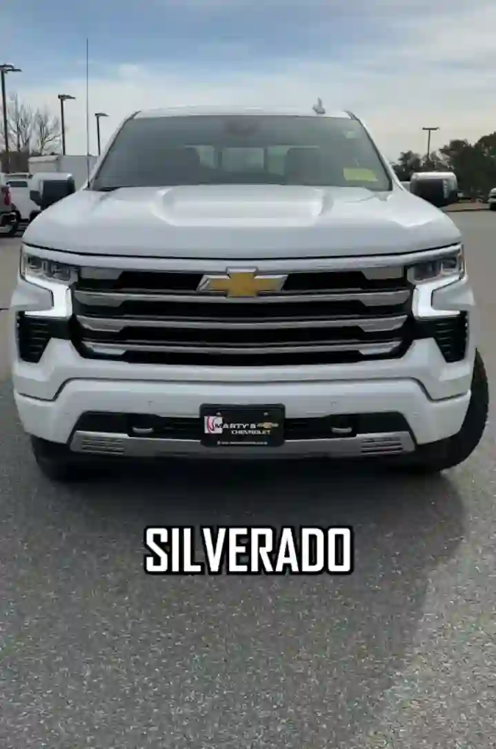 A customized Chevy Silverado 1500 truck showcasing a variety of top-notch parts and accessories for sale, including upgraded tires, a rugged grille guard, sleek running boards, and powerful LED headlights